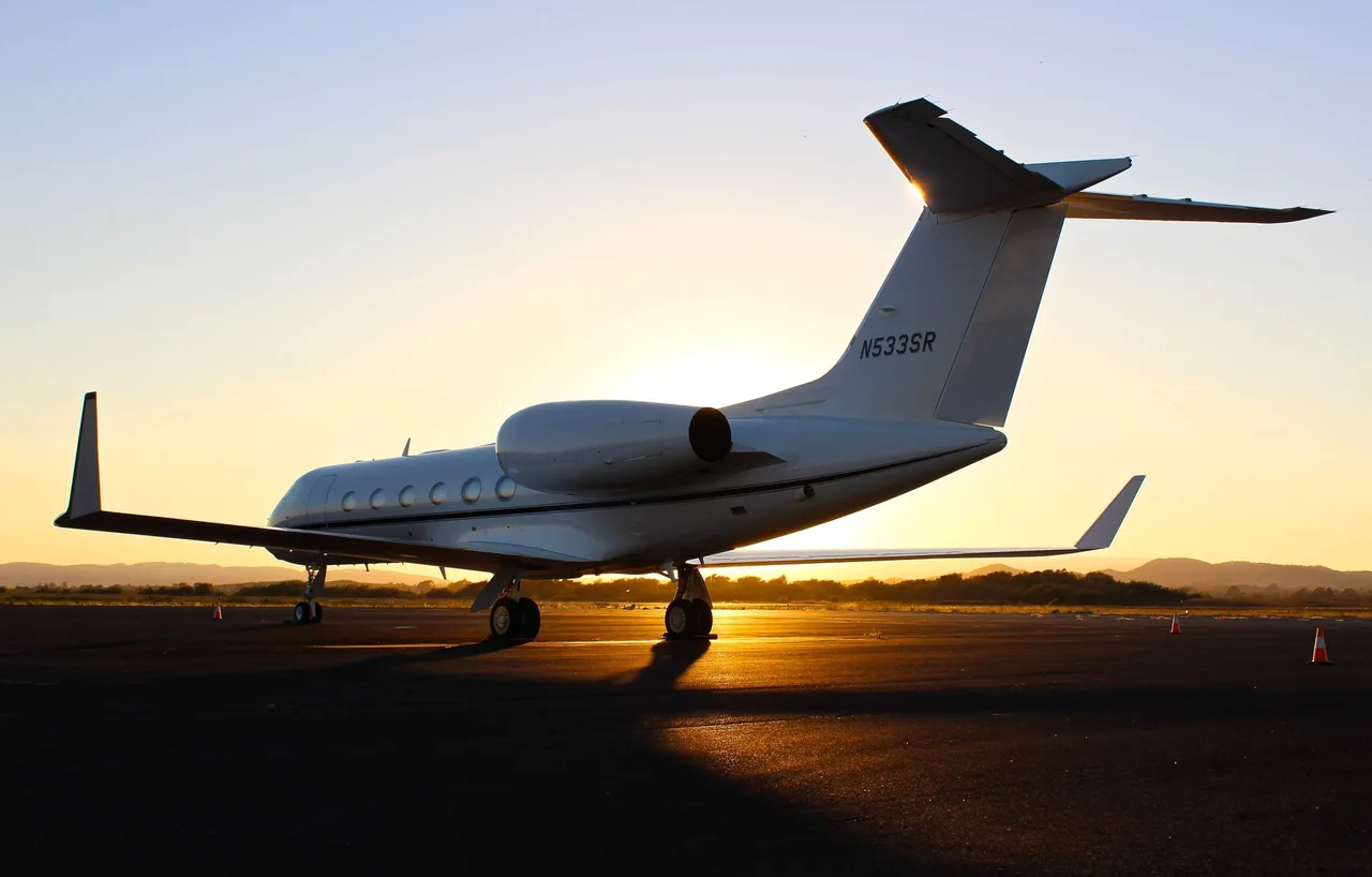 Business aircraft taxiing at sunset