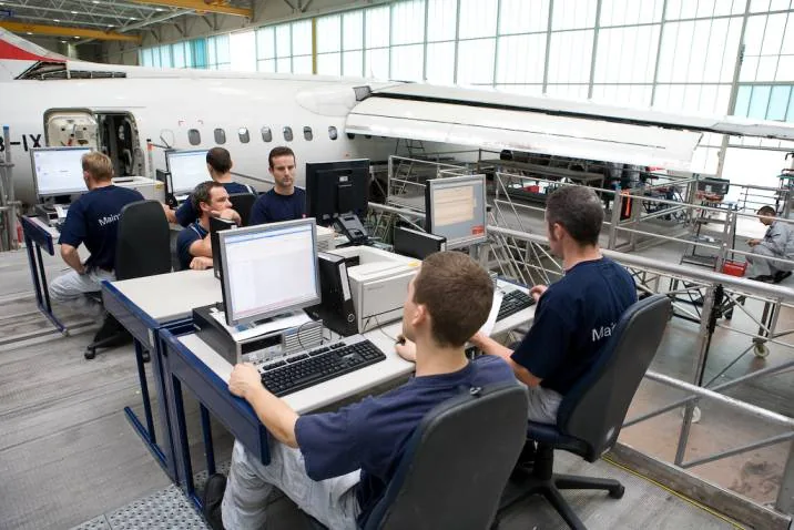 Aviation operations team working together at computers
