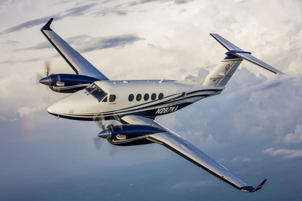 Business aircraft flying above the clouds